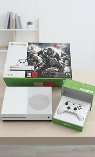 The same console, controller and box on a bright, tidy desk.