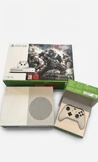 The same console, controller and box on a white studio background.